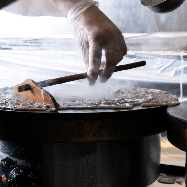 A crepe being prepared on a bilig